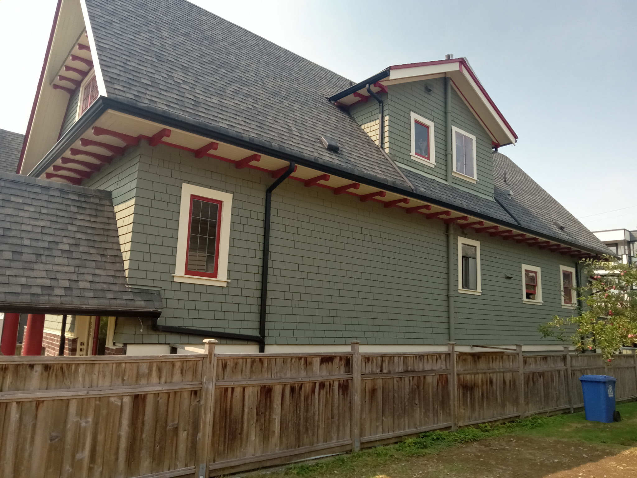 Finished side elevation with fresh green siding and red roof details